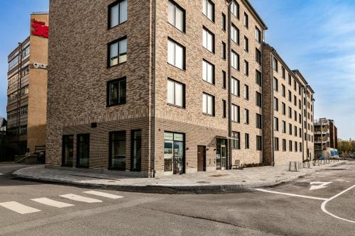 a tall brick building on the corner of a street at Cosy Urban Home in Stockholm in Stockholm