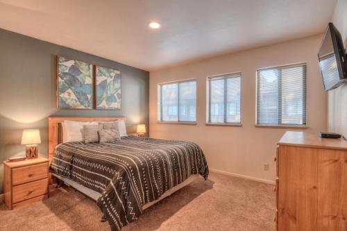 a bedroom with a bed and a flat screen tv at Powder Village Unit D8 in Sunriver