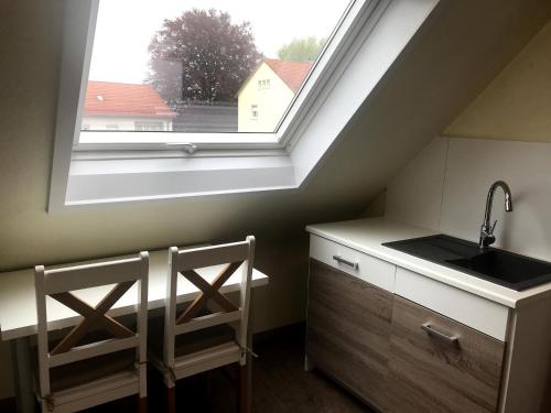 a kitchen with a sink and a window at Appartment Hotel Garni Elisabeth in Göppingen