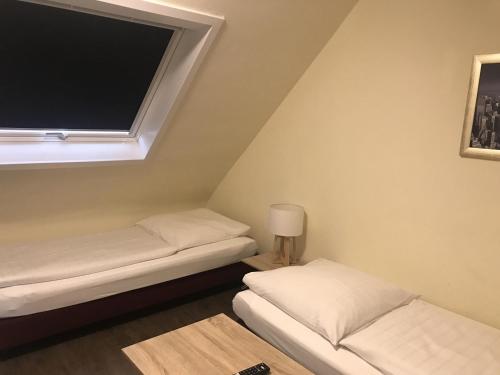 a room with two beds and a flat screen tv at Appartment Hotel Garni Elisabeth in Göppingen