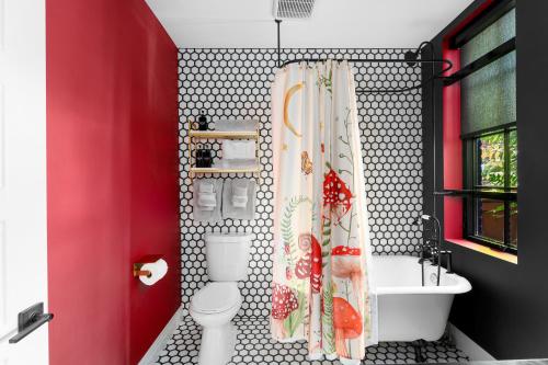 a bathroom with a toilet and a shower curtain at The Acoma House in Denver