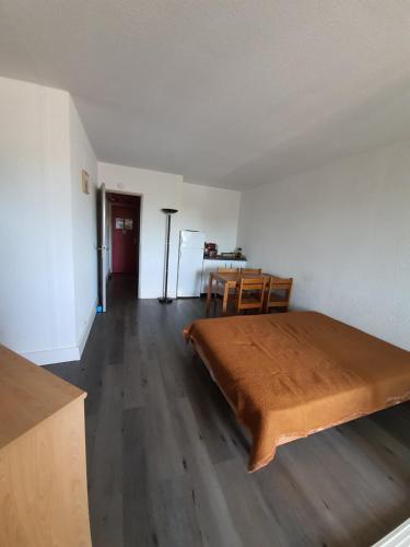 ein Schlafzimmer mit einem großen Bett und einem Tisch in der Unterkunft Studio 233, Port Camargue, Parking, WiFi, Piscine, 2 personnes in Le Grau-du-Roi
