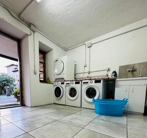 a laundry room with two washing machines in it at DOLOMITI HOUSE 4 in Fiera di Primiero