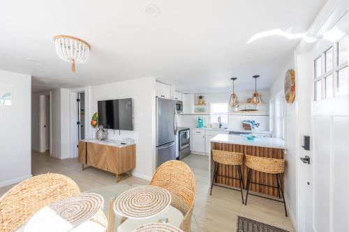 a kitchen with white cabinets and a table and chairs at Beach Block-1min Walk-Luxury-The Reef Downstairs in Ocean City