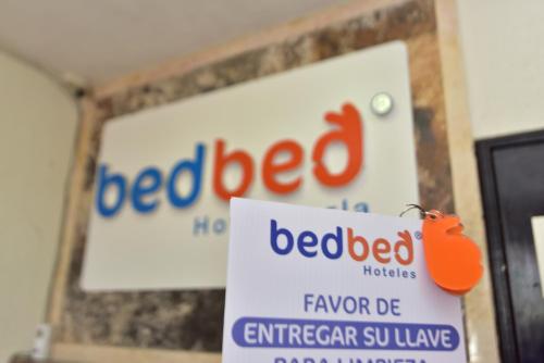 a sign for a bed beef store with a red beef sign at Bed Bed Hotel Perla in Torreón