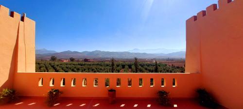 a large window with a view of a vineyard at Kasbah ATFEL in Ourika