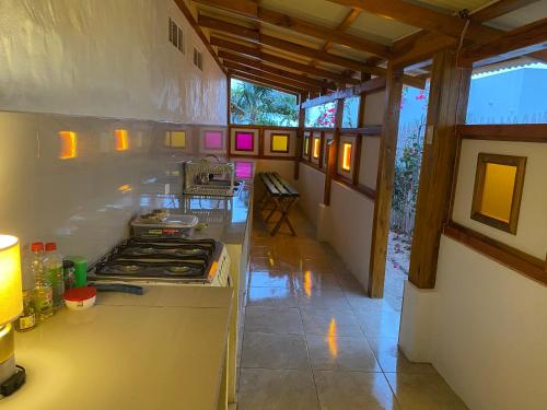 a kitchen with a stove top oven in a room at Jardin Pacifico in Canoa