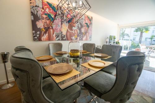 a dining room with a glass table and chairs at Sublime Coliseum in Ponta Delgada