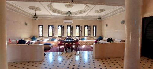 a living room with couches and a table in the middle at Kasbah ATFEL in Ourika