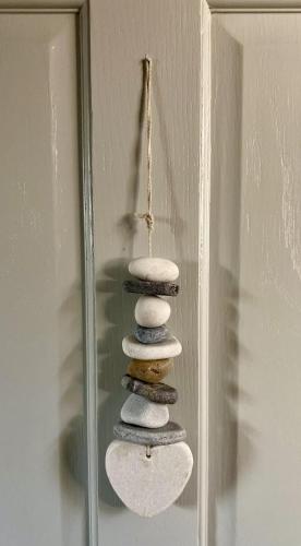 a stack of rocks sitting on top of a mirror at Chestnut Tree Cottage, 7 High Street in Ardingly