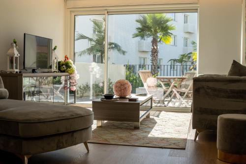 a living room with a couch and a table at Sublime Coliseum in Ponta Delgada