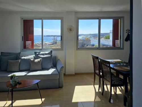 a living room with a couch and a table at Live Poris La Morra in Poris de Abona