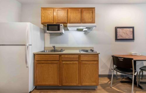 a kitchen with a sink and a white refrigerator at Extended Stay America Select Suites - Austin - Northwest in Jollyville