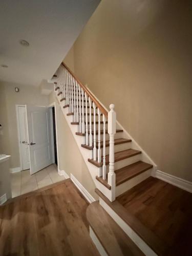 a staircase in a home with wooden floors at Beautiful Master bedroom unit with private washroom in Mississauga