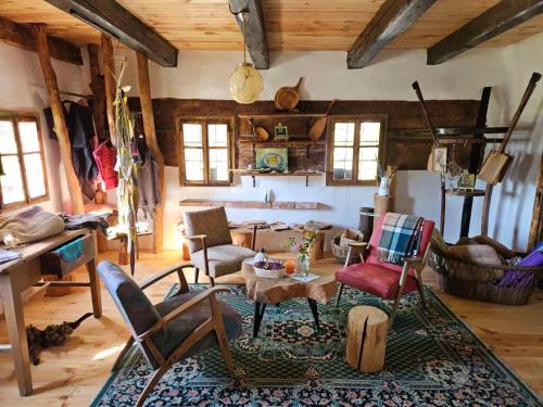 a living room with chairs and a table in a room at Estate Ana in Ptuj