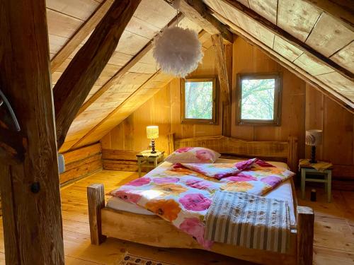 a bedroom with a bed in a wooden cabin at Estate Ana in Ptuj
