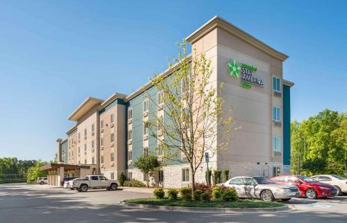 a hotel with cars parked in a parking lot at Extended Stay America Suites - Charlotte - Matthews in Charlotte