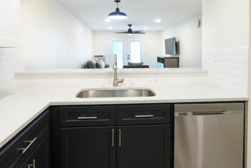 a kitchen with black cabinets and a sink at Legacy Vacation Resorts Steamboat Springs Suites in Steamboat Springs