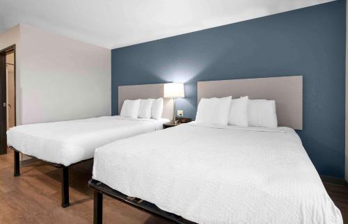 two beds in a room with blue walls at Extended Stay America Suites - Boston - Saugus in Saugus