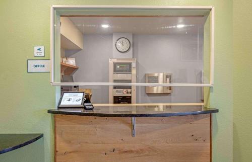 a counter in a room with a clock on the wall at Extended Stay America Select Suites - Cleveland - Mentor in Mentor