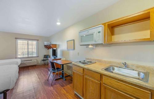 a small kitchen with a sink and a microwave at Extended Stay America Select Suites - Cleveland - Mentor in Mentor