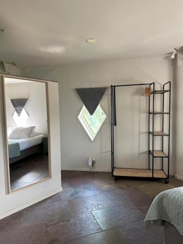 a bedroom with a mirror and a bed and a bed sqor at Hotel de Watertoren in Dordrecht