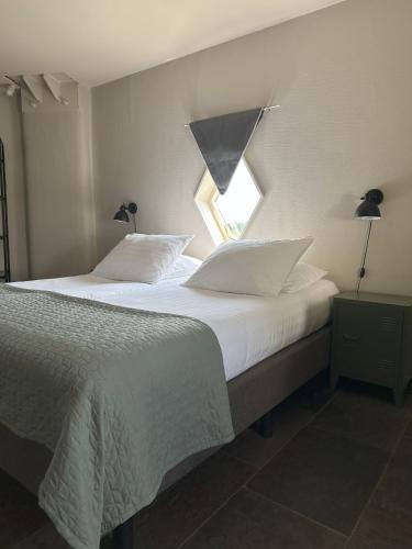 a bedroom with two beds and a window at Hotel de Watertoren in Dordrecht