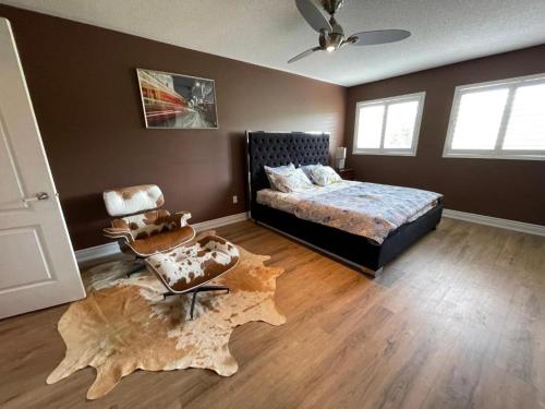 a bedroom with a bed and a wooden floor at Beautiful Master bedroom unit with private washroom in Mississauga