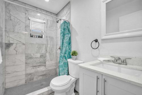 a bathroom with a toilet and a shower and a sink at West Brickell - #3 - Renovated 2 1 & Parking in Miami