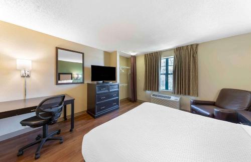 a hotel room with a bed and a desk and chair at Extended Stay America Suites - Philadelphia - Cherry Hill in Maple Shade