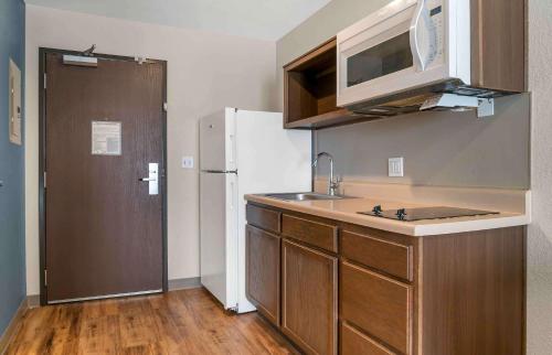 a kitchen with a sink and a white refrigerator at Extended Stay America Suites - Detroit - Rochester Hills in Rochester Hills