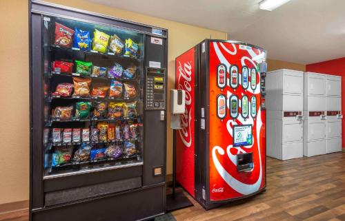 a cocacola soda machine next to a soda refrigerator at Extended Stay America Suites - Philadelphia - Cherry Hill in Maple Shade