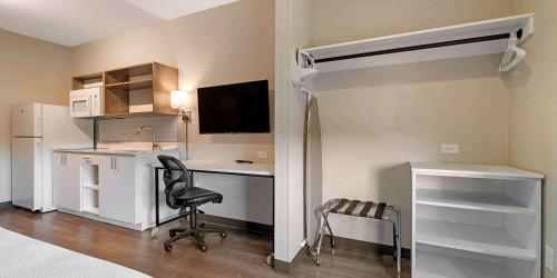 a bedroom with a bed and a desk with a computer at Extended Stay America Premier Suites - Savannah - Pooler in Savannah