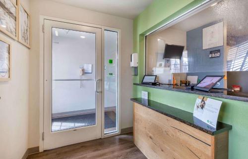 a restaurant with a counter with a glass door at Extended Stay America Select Suites - Gainesville in Gainesville