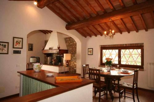 a kitchen and living room with a table and a dining room at Agriturismo San Silvestro in San Donato in Poggio