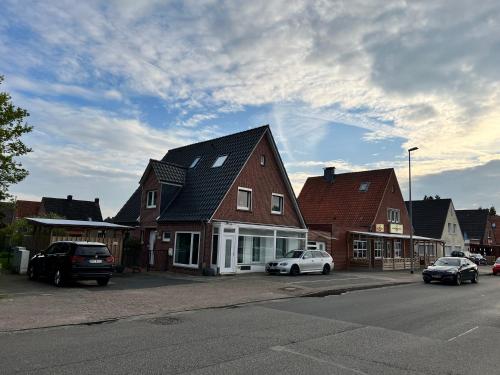 a group of houses with cars parked in a parking lot at Apartment Haus-Lisa Studio 1 in Emden