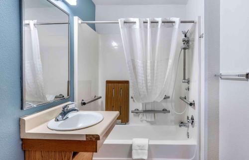 a white bathroom with a sink and a shower at Extended Stay America Select Suites - Louisville - South 