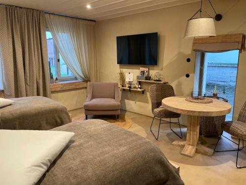 a hotel room with two beds and a table and chair at Lark One in Schleibnitz