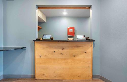 a wooden cabinet with two computers on top of it at Extended Stay America Select Suites - Mobile - Daphne in Daphne