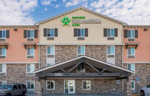 a front view of a hotel with cars parked in front at Extended Stay America Suites - Norco in Norco