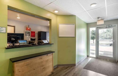 an office with green walls and a desk and a window at Extended Stay America Select Suites - Pensacola - Northeast in Pensacola
