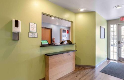 a room with a counter with a mirror and a cash register at Extended Stay America Select Suites - Orlando - East in Orlando