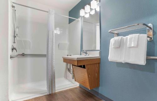 a bathroom with a shower and a sink and a toilet at Extended Stay America Select Suites - Pensacola - Northwest in Pensacola