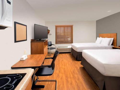a hotel room with two beds and a desk at Extended Stay America Select Suites - Provo - American Fork in Lehi