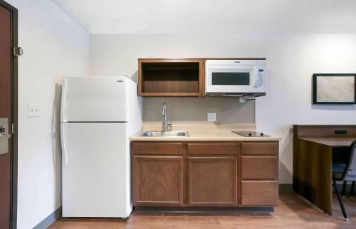 a kitchen with a white refrigerator and a microwave at Extended Stay America Suites - Providence in Providence