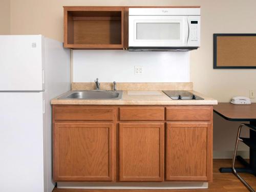 a kitchen with a sink and a microwave at Extended Stay America Select Suites - Shreveport - Bossier City in Bossier City