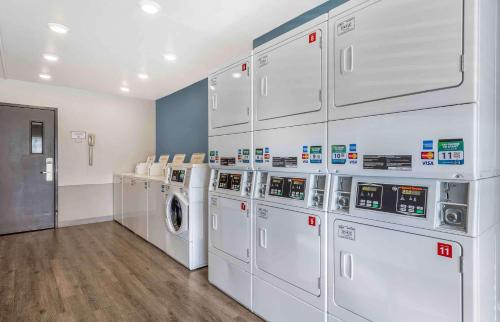 a laundry room with white washers and dryers at Studio 6 Extended Stay Wichita South KS in Wichita