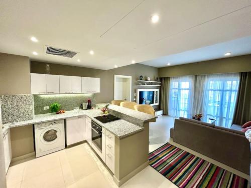 a large kitchen with a stove and a dishwasher at SunShine AbuTig Marina in Hurghada