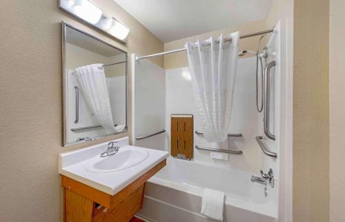 a white bathroom with a sink and a shower at Extended Stay America Select Suites - Oklahoma City - Southeast in Moore