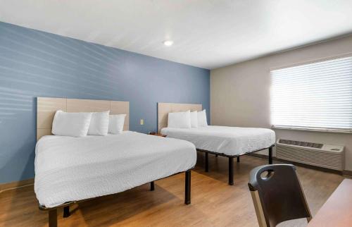 a room with two beds and a window in it at Extended Stay America Select Suites - Fayetteville - I-49 in Fayetteville
